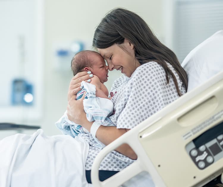 New mother holding newborn after giving birth