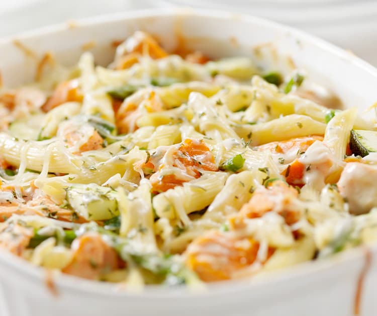 Close up of penne with salmon and roasted vegetables